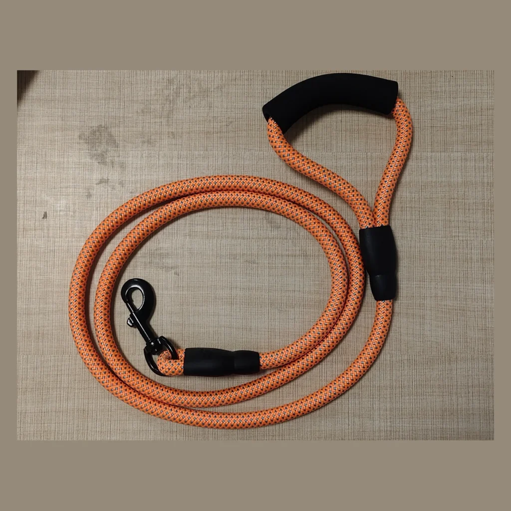 Custom orange round braided dog leash with foam handle and black metal snap hook