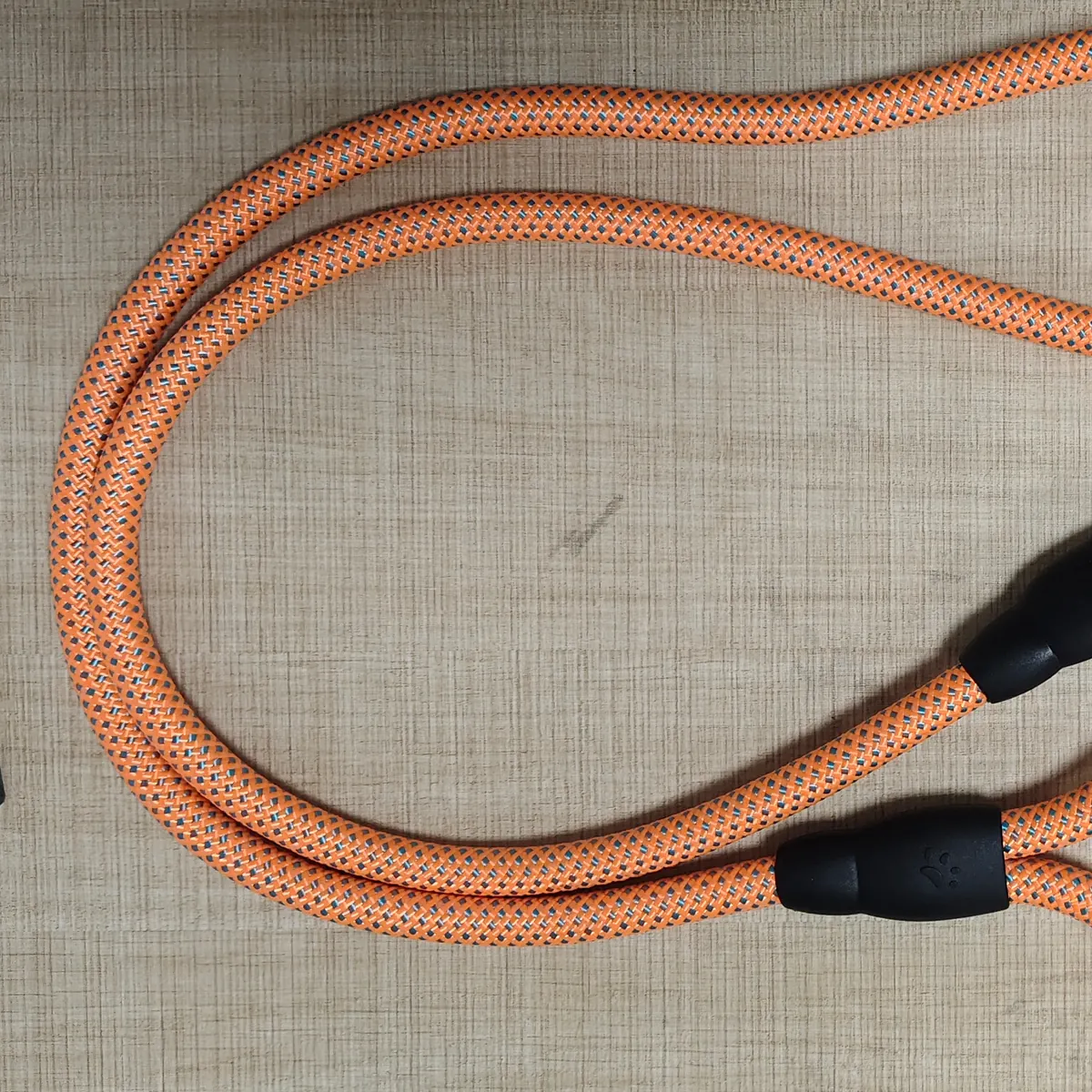 Close-up of the orange polyester round braided rope texture used for a dog leash