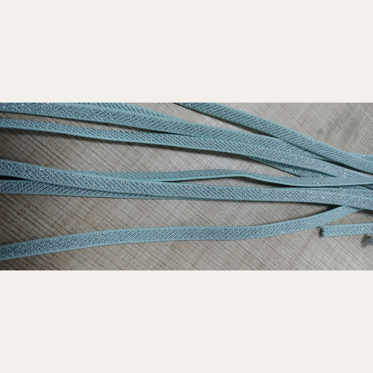 Close up of silver metallic yarn texture on 6mm elastic band
