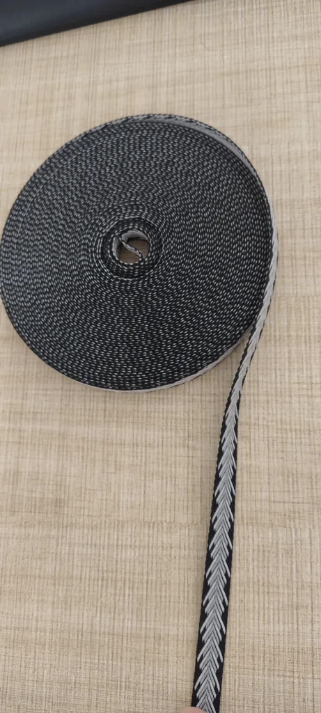 Roll of black and white 10mm polyester jacquard webbing