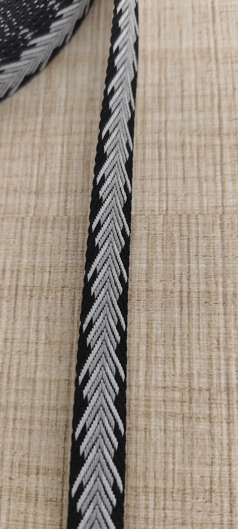 Close-up of 10mm black and white herringbone jacquard webbing