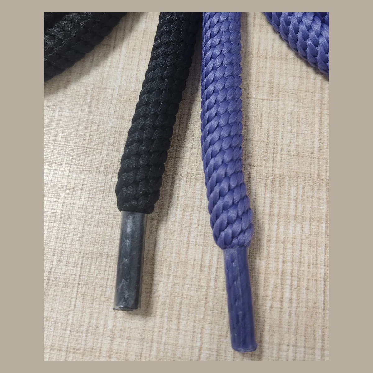 Close-up of braided 10mm polyester round shoelaces and plastic aglets