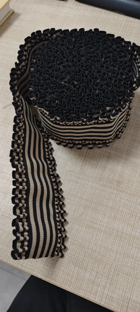 Rolled black and beige 60mm striped elastic band with wavy edges